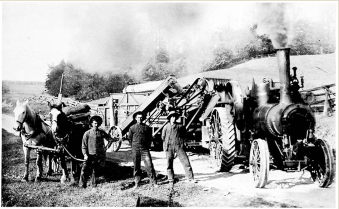 Traction steam engine hauling a threshing machine on Mill Rd, King Creek, 1909